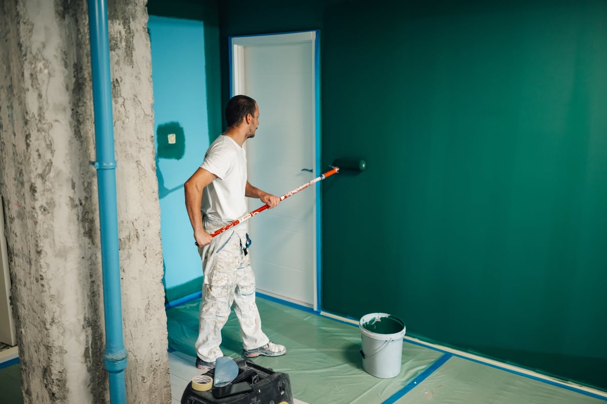 Professional painter applying paint on a wall